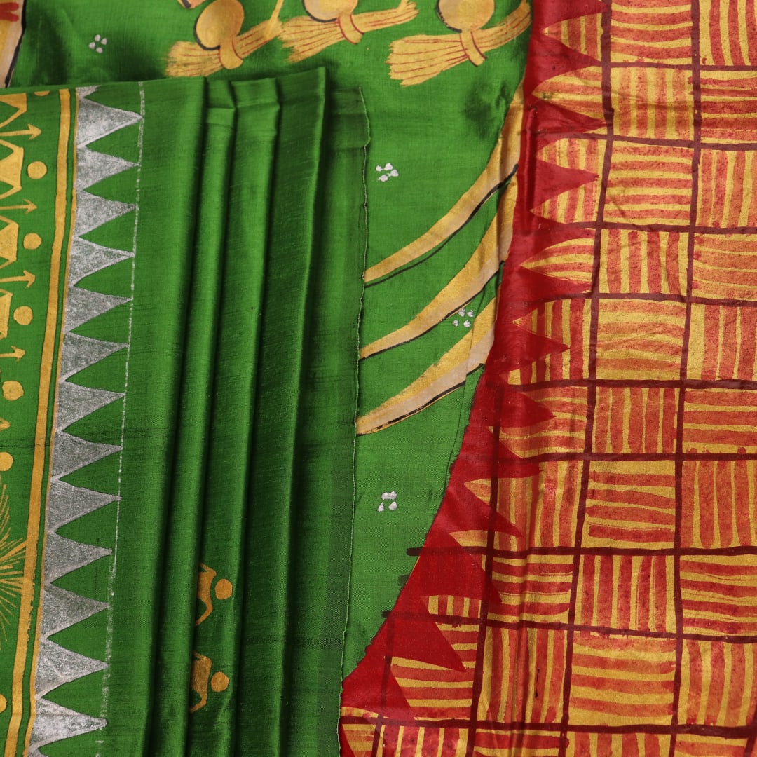 Close-up of green Patachitra silk saree, showcasing the handloom weave and fabric texture.