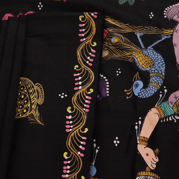 Close-up of black silk Patachitra saree fabric, showcasing hand-painted texture and detail.
