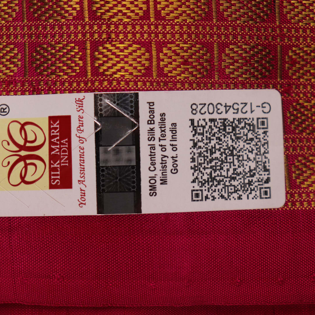 Close-up of black Sambalpuri silk saree fabric texture with subtle motifs and magenta threads.