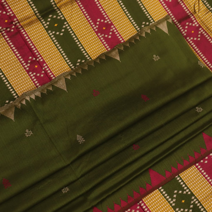 Close-up of the textured green Sambalpuri Silk Saree fabric, highlighting the woven butta pattern.