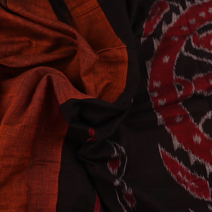 Brown and black plain Sambalpuri cotton saree elegantly draped.
