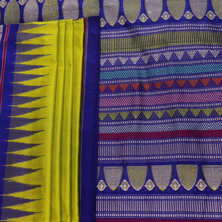 Close-up of green and blue Dongria silk saree fabric texture with butta pattern.