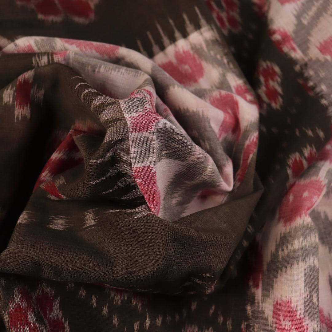 Off-white Sambalpuri cotton saree with green motifs, elegantly draped.