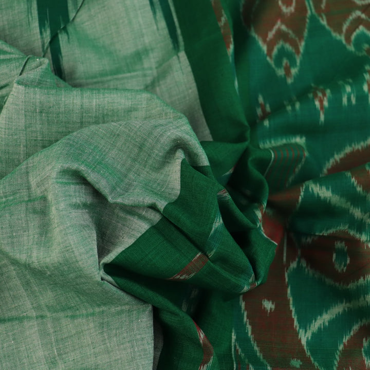 Model wearing a plain green Sambalpuri cotton saree, elegantly draped.