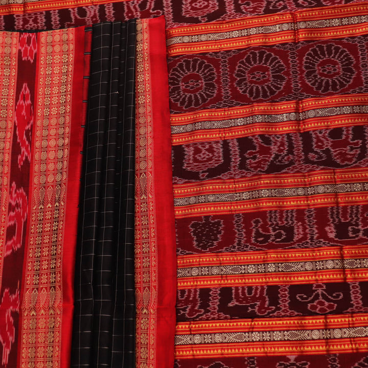 Close-up of black and red striped Sambalpuri silk saree's woven texture.