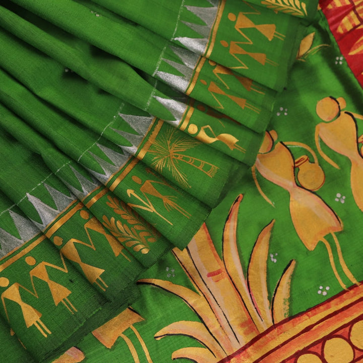 Close-up of green Patachitra silk saree, showcasing the handloom weave and fabric texture.