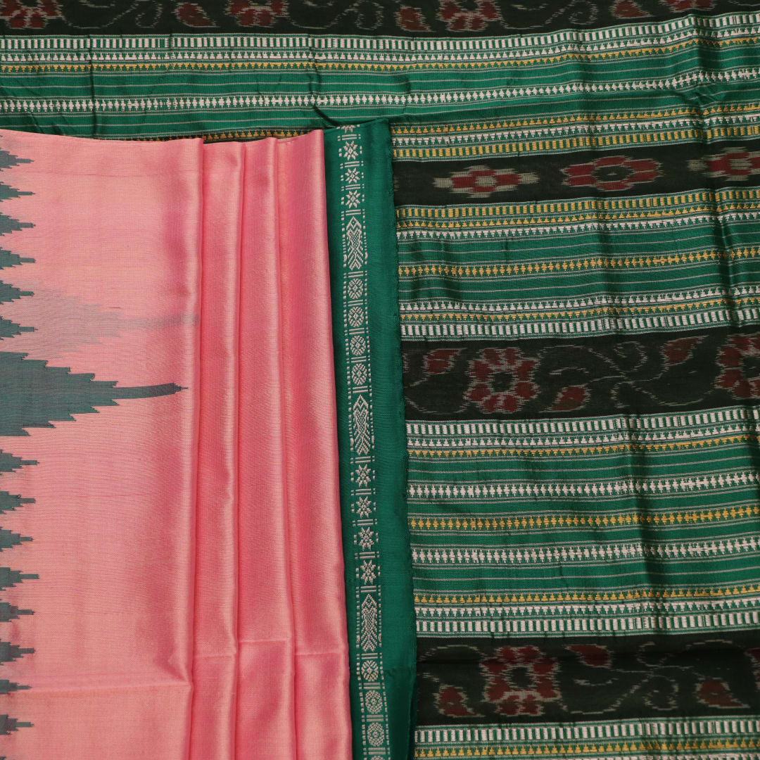 Close-up of the plain woven silk texture of a pink and green Sambalpuri saree.