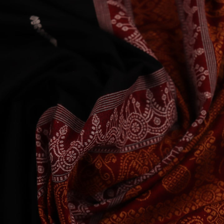 Full view of a black cotton Bomkai saree with rust-colored butta patterns and pallu.