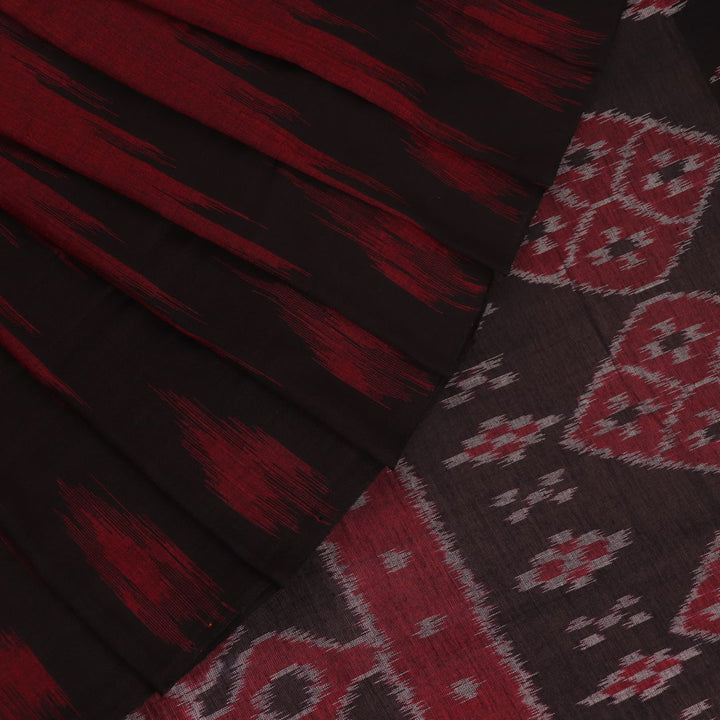 Gracefully draped maroon and black plain Sambalpuri cotton saree.