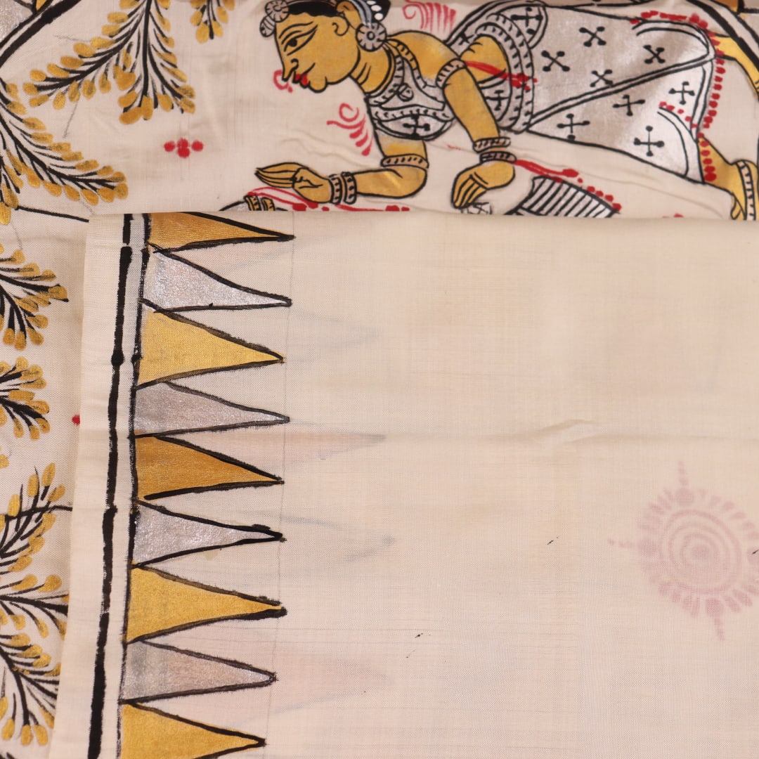 Close-up of white silk Patachitra saree, showcasing the handloom fabric's texture and subtle paint details.