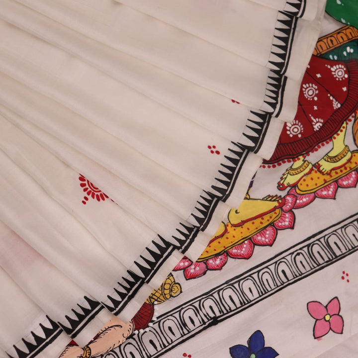 Close-up of handloom white silk Patachitra saree fabric showing texture and hand-painted details.