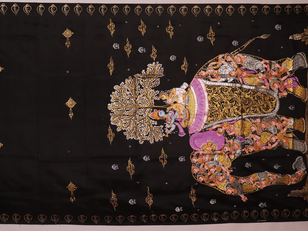 Close-up of black silk Patachitra saree fabric, showcasing hand-painted texture and detail.