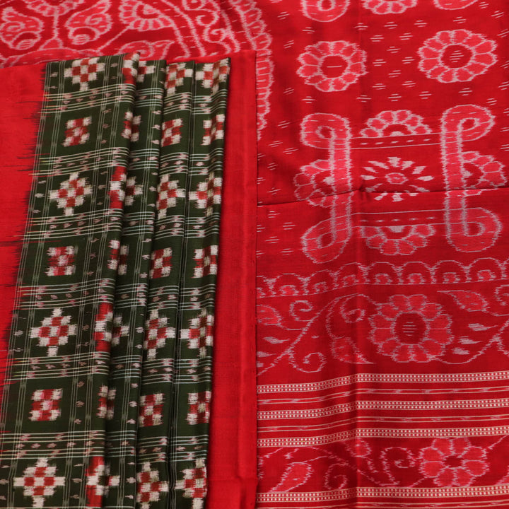 Close-up of green Sambalpuri silk saree fabric showing intricate woven motif texture and red thread details.