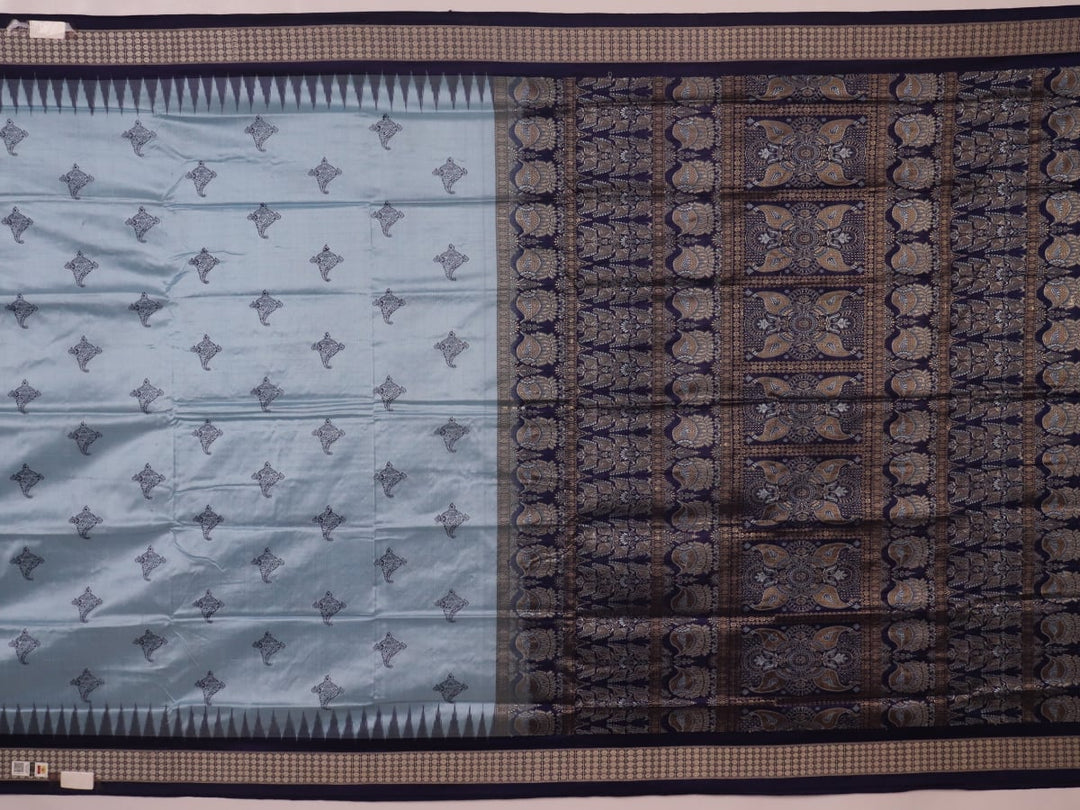 Close-up fabric texture of a blue Bomkai silk saree, revealing intricate butta pattern weave.
