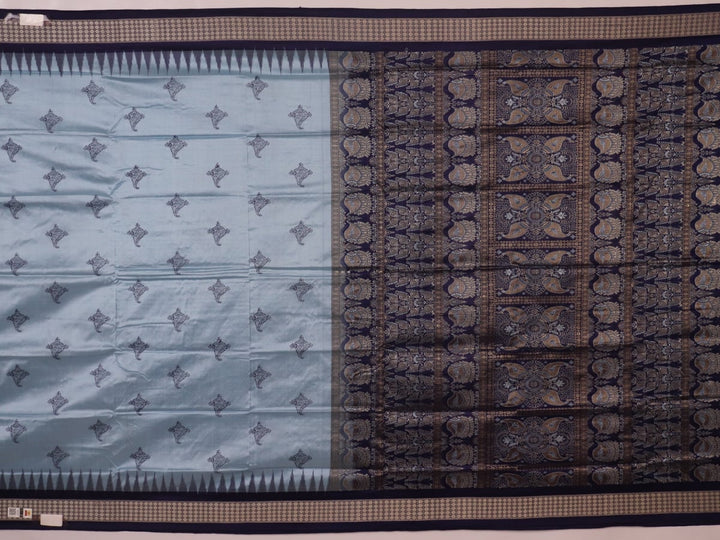 Close-up fabric texture of a blue Bomkai silk saree, revealing intricate butta pattern weave.