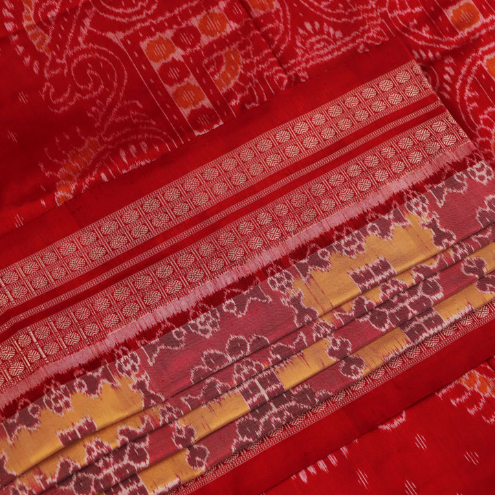 Close-up of multicolored silk Sambalpuri saree fabric showing intricate handloom weave texture.