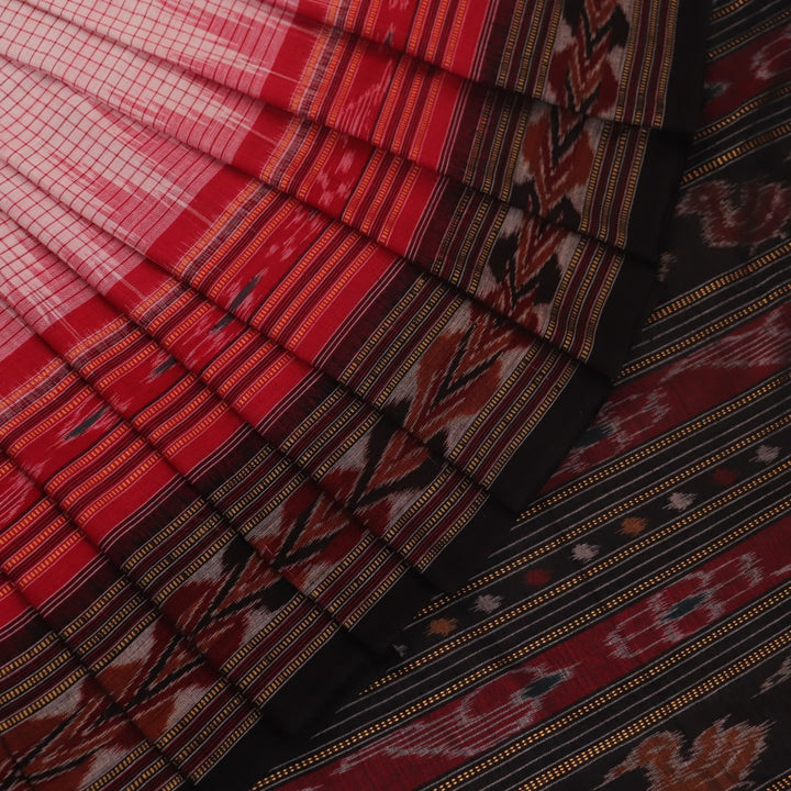 Woman draped in a white and black Sambalpuri cotton saree with motifs.