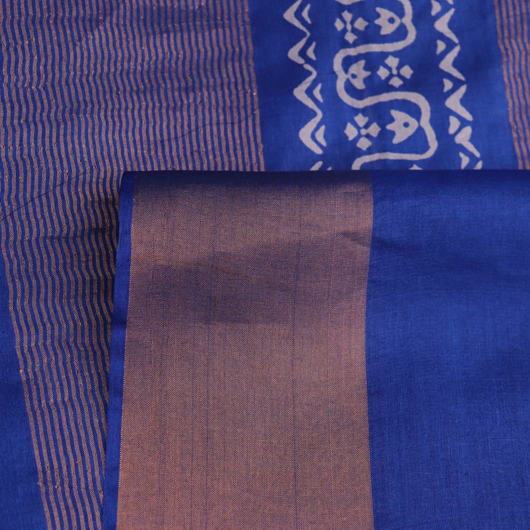 Close-up of blue printed Tussar silk handloom saree fabric texture.