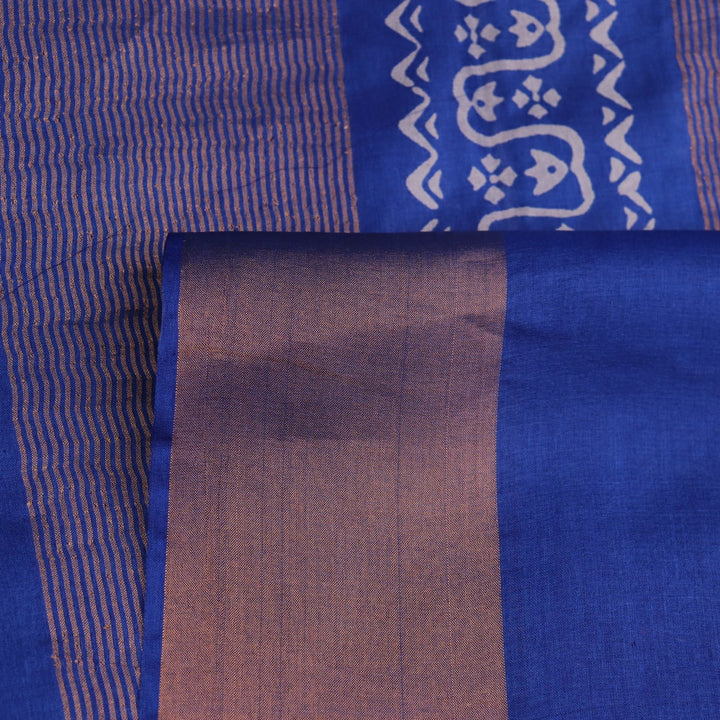 Close-up of blue printed Tussar silk handloom saree fabric texture.