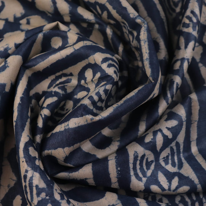 Close-up of blue printed Tussar silk saree fabric texture.
