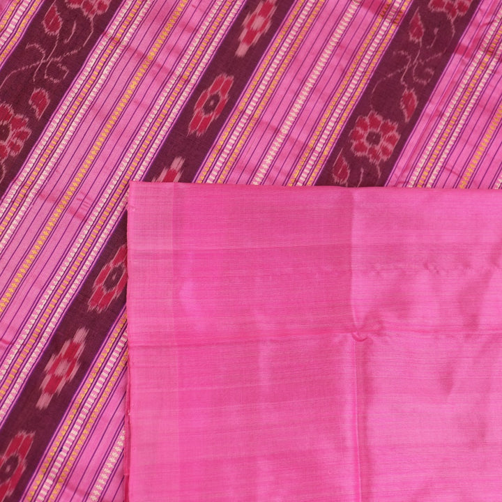 Close-up of green and pink plain Sambalpuri silk saree fabric texture.
