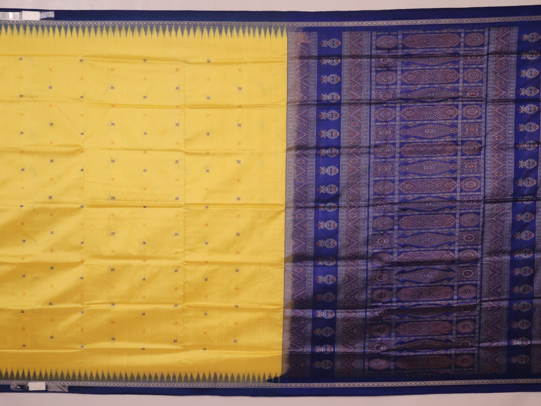 Textured close-up of yellow Bomkai silk saree fabric with blue butta pattern.