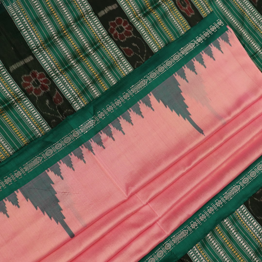Close-up of the plain woven silk texture of a pink and green Sambalpuri saree.