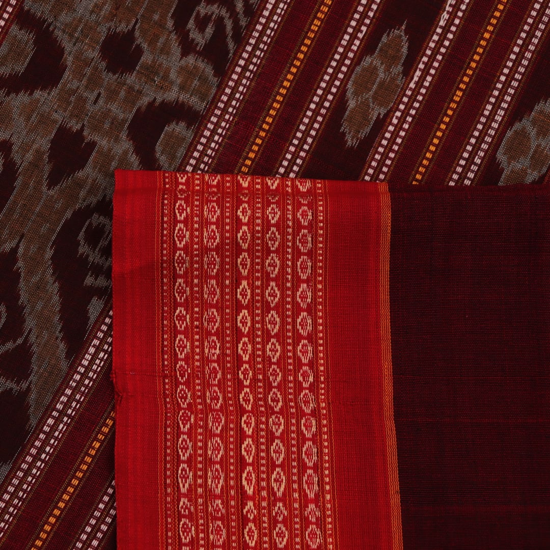 A brown and red Bomkai cotton saree with butta pattern on display