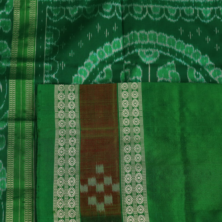 Close-up of magenta Sambalpuri silk saree fabric texture, showcasing intricate handloom weave and subtle motifs.
