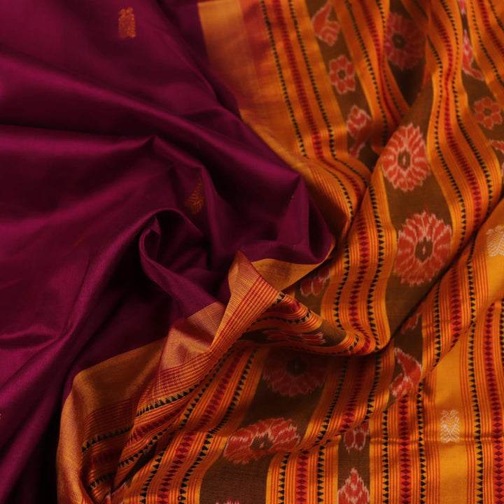 Close-up fabric texture of a magenta Sambalpuri Silk Saree with yellow butta pattern.