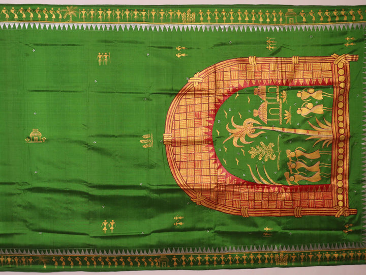 Close-up of green Patachitra silk saree, showcasing the handloom weave and fabric texture.