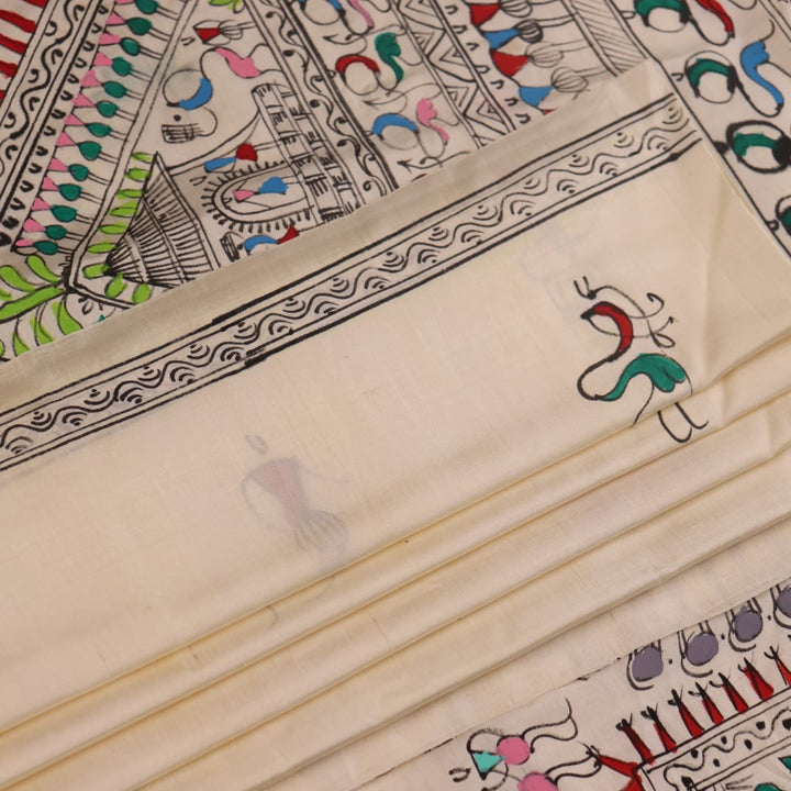 Close-up of the white silk saree fabric texture, showcasing the handloom weave and painted Patachitra details.
