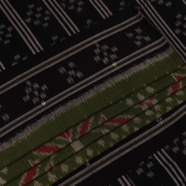 Green and black Sambalpuri cotton saree with motifs, elegantly draped.