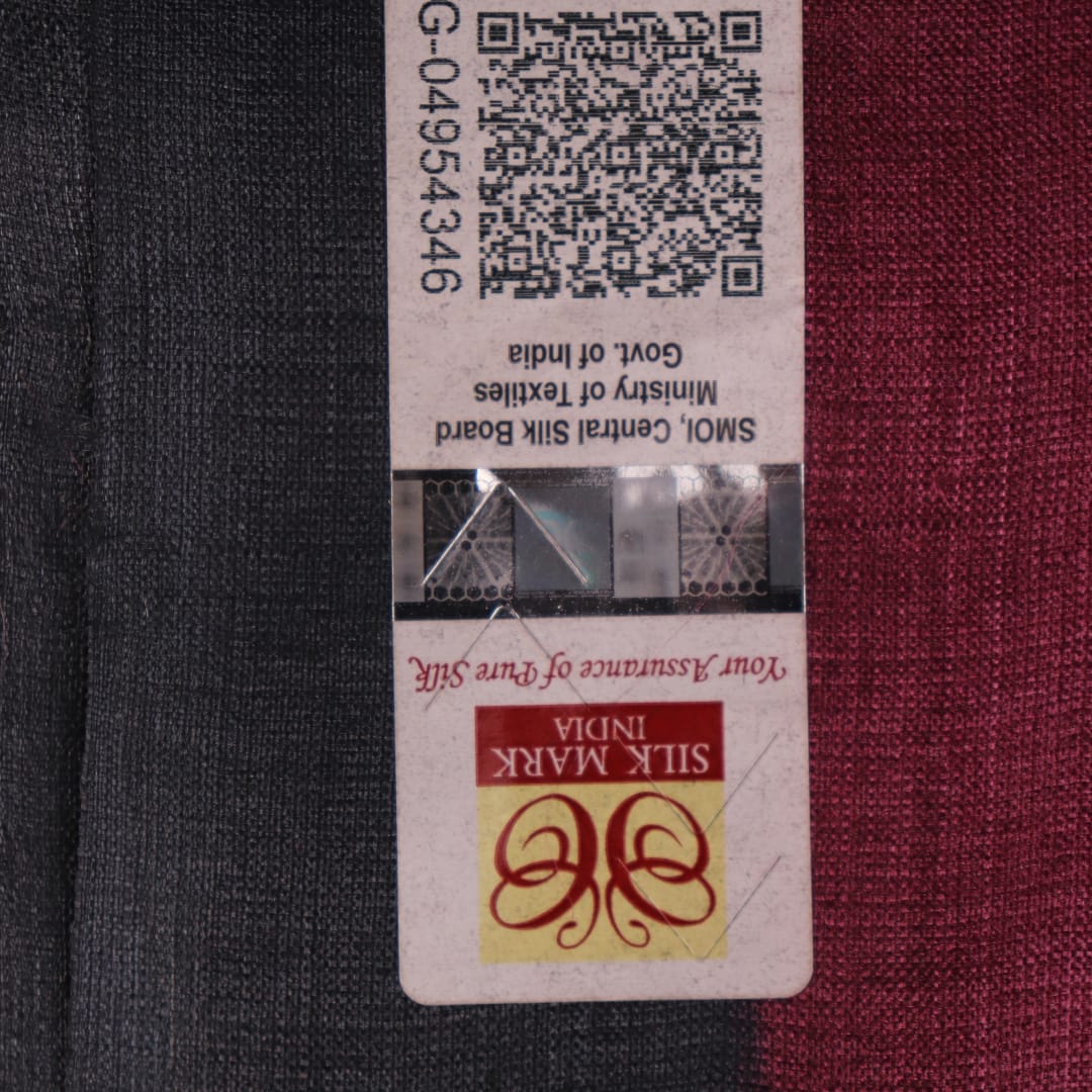 Close-up of off-white Tussar silk fabric, highlighting natural slubs and printed black pattern.