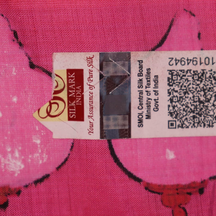 Close-up of pink silk Patachitra saree fabric, showcasing hand-painted texture and fine details.