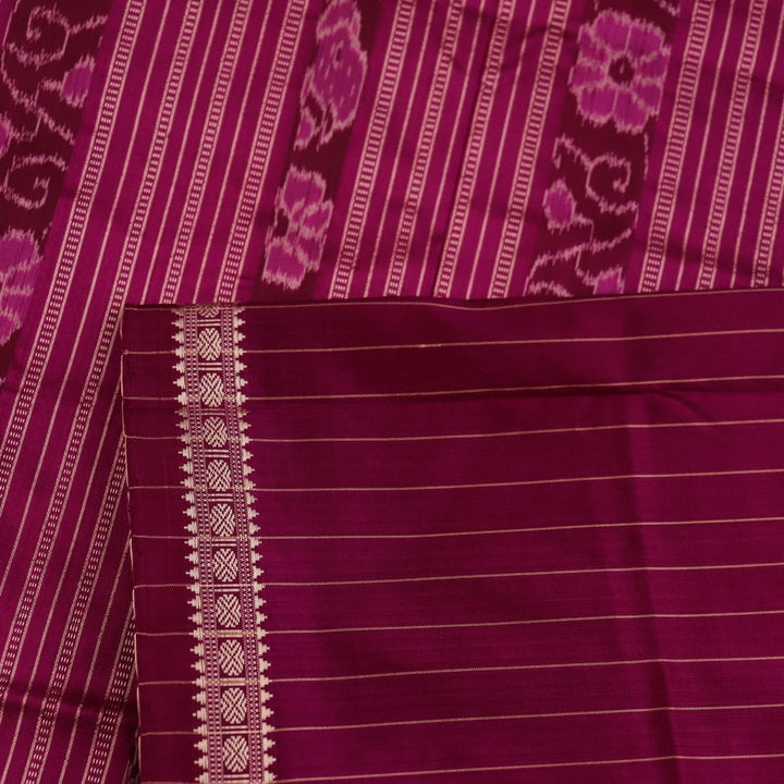Close-up of plain cream and magenta Sambalpuri Silk Saree fabric texture.