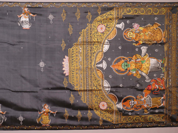 Close-up of handloom grey silk Patachitra saree fabric texture, revealing the intricate details of the hand-painted design.