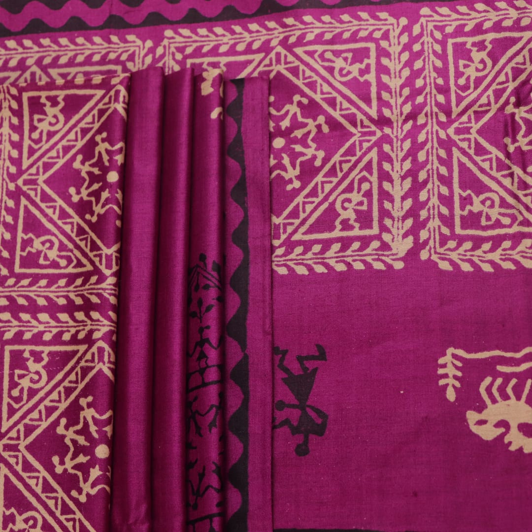 Close-up of magenta Tussar silk saree fabric, showing the printed pattern and natural slub texture.
