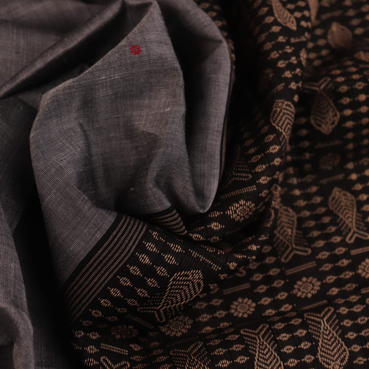 Full view of grey Bomkai cotton saree, featuring black border and butta pattern.