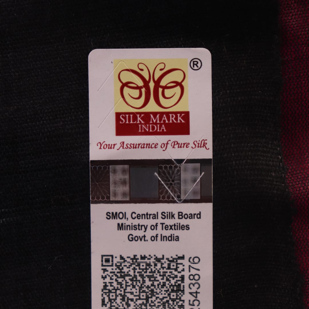Close-up of plain white and black handloom Tussar Silk saree fabric texture.