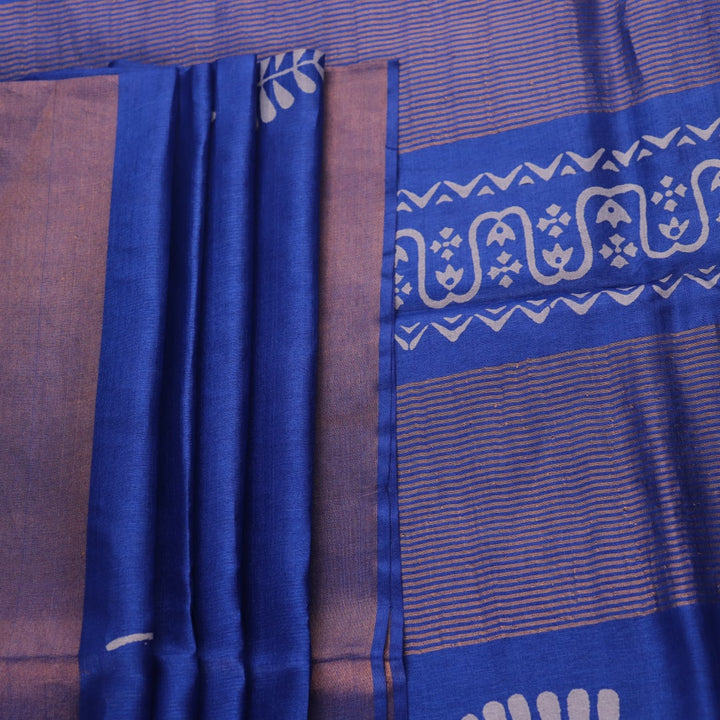 Close-up of blue printed Tussar silk handloom saree fabric texture.