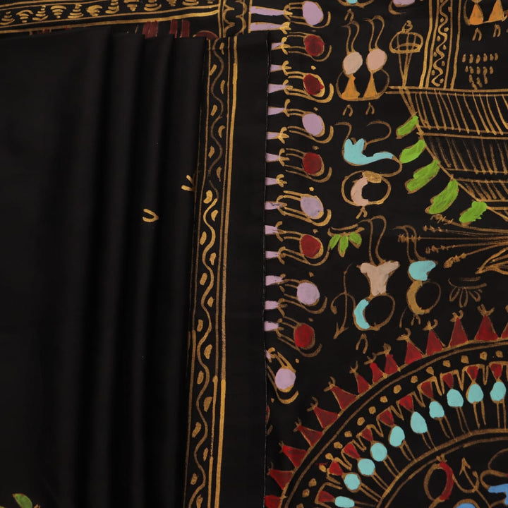 Close-up of the black silk Patachitra saree, showcasing the hand-painted fabric texture.