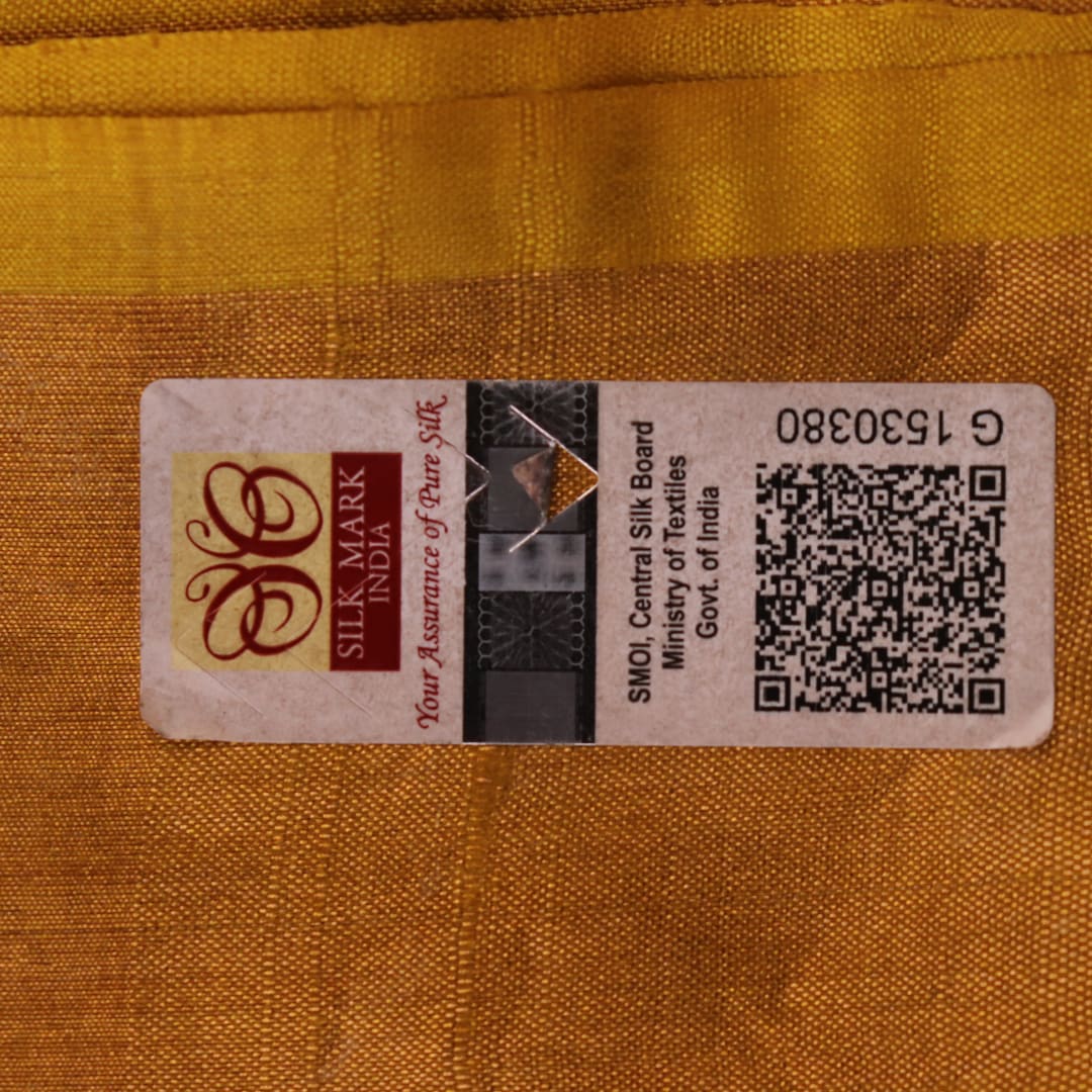 Close-up of the yellow printed Tussar silk saree's distinct slubby fabric texture.