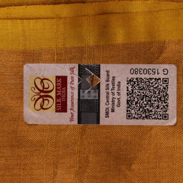 Close-up of the yellow printed Tussar silk saree's distinct slubby fabric texture.