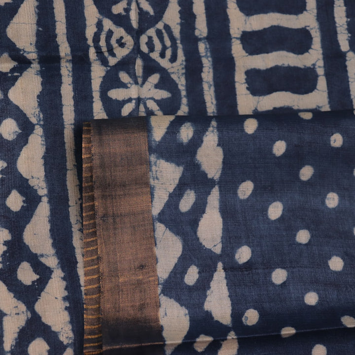 Close-up of blue printed Tussar silk saree fabric texture.