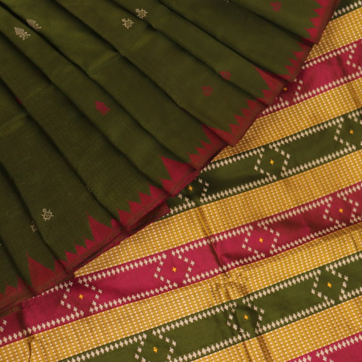 Close-up of the textured green Sambalpuri Silk Saree fabric, highlighting the woven butta pattern.