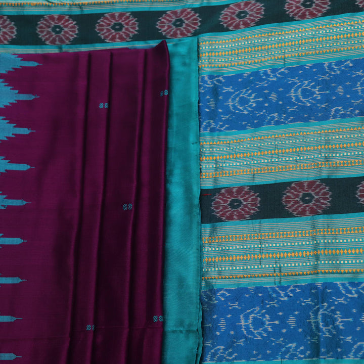 Close-up of the textured weave of a purple Sambalpuri silk saree with green accents and butta pattern.