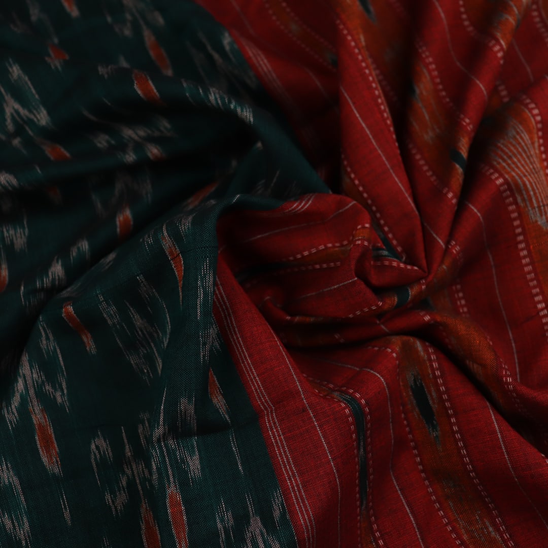 Green and orange Sambalpuri cotton saree draped, showcasing the motif pattern.