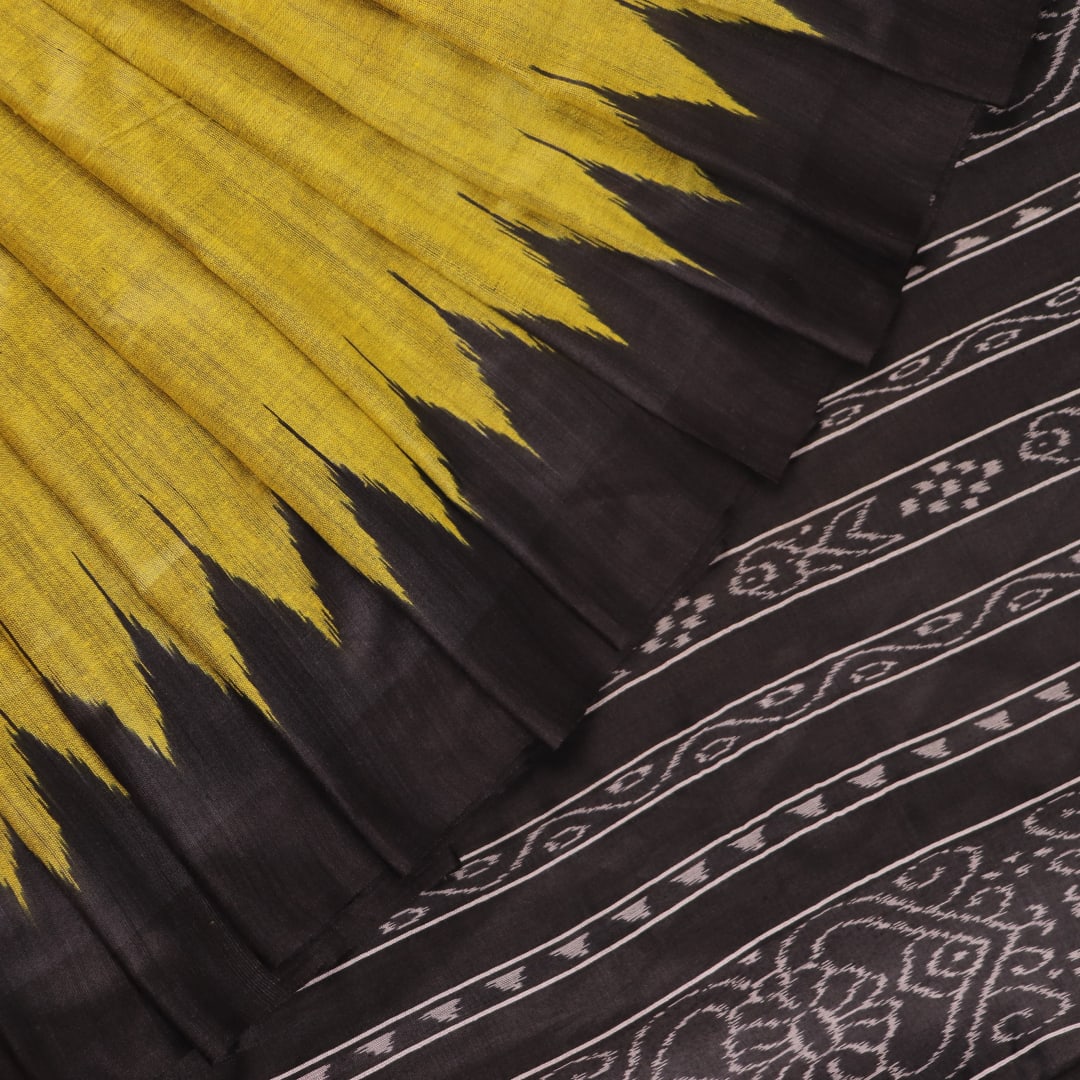 Close-up of the plain, slubby texture of a handwoven green and black Tussar silk saree.