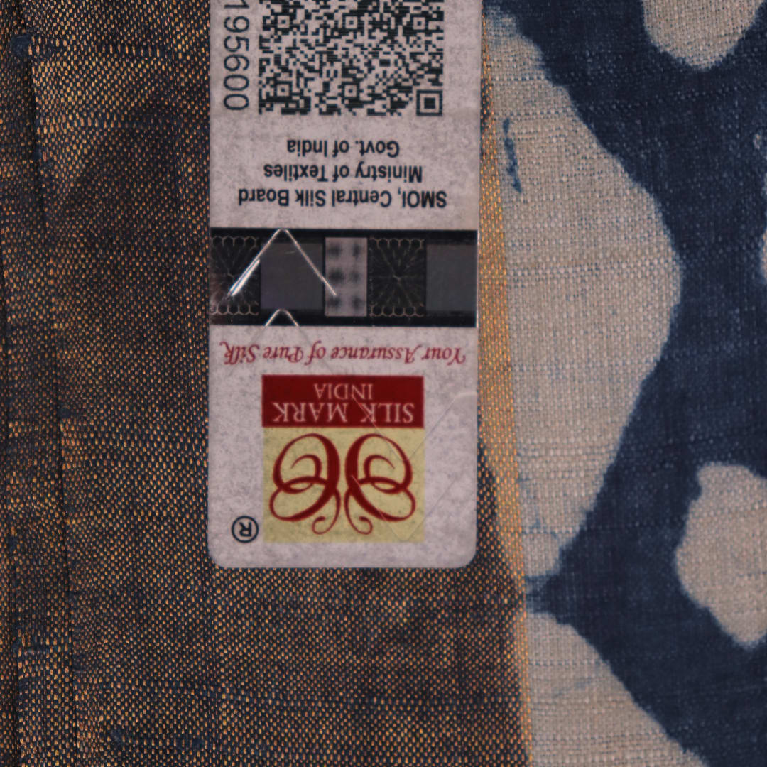 Close-up of blue printed Tussar silk saree fabric texture.